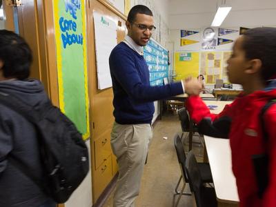 Teacher fist bumping a student